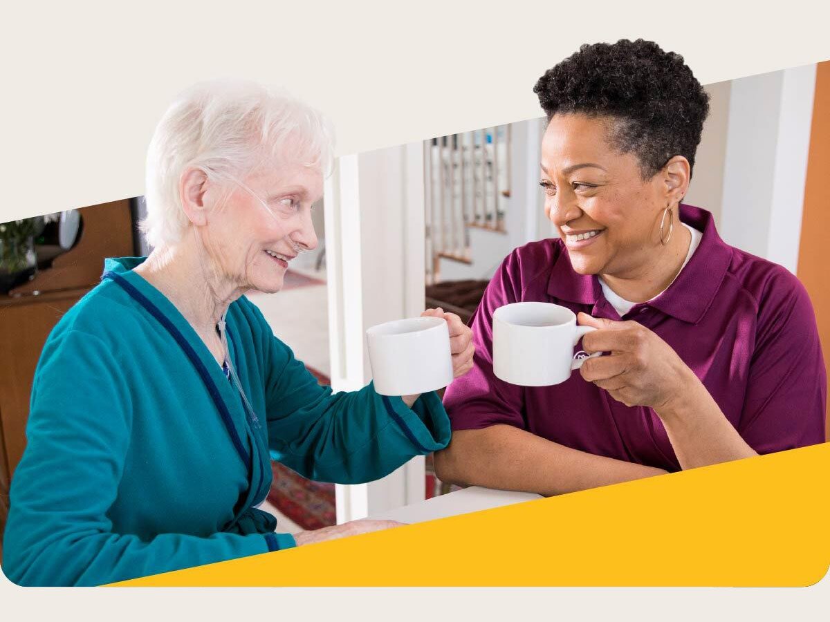 Aging woman and Care Professional smile and enjoy coffee together